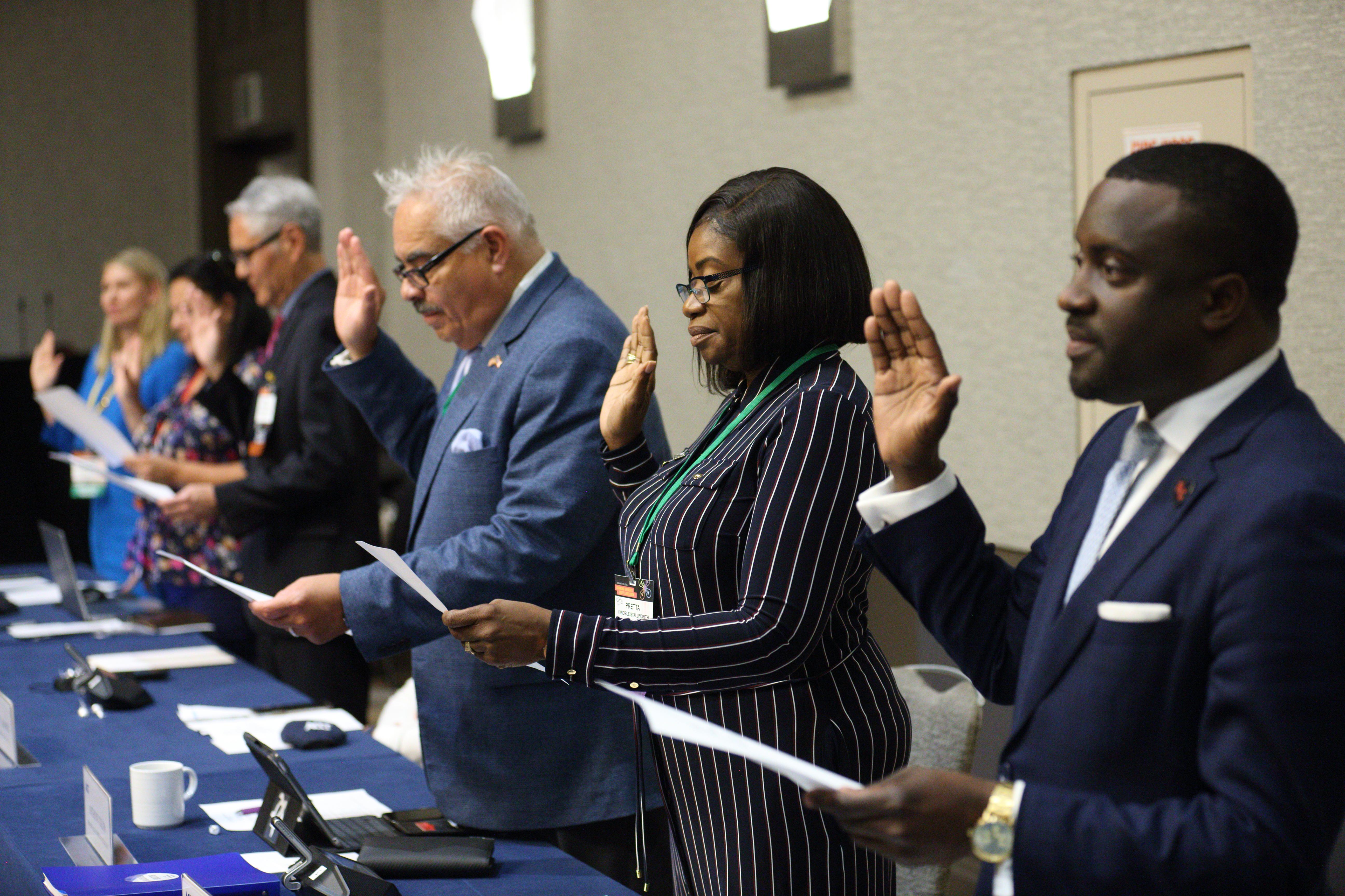 Community college trustees take oath of office.